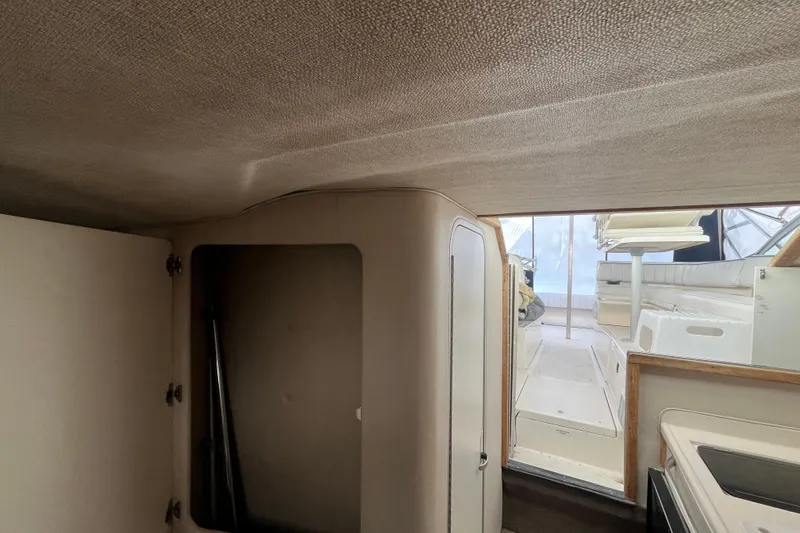 Slide: The Image of Interior view of 1994 Sea Ray 310 Amberjack boat, featuring cabin and seating area. - 31