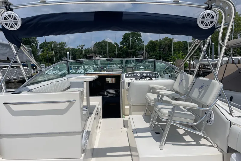 Slide: The Image of 1994 Sea Ray 310 Amberjack boat interior with seating and control panel. - 7