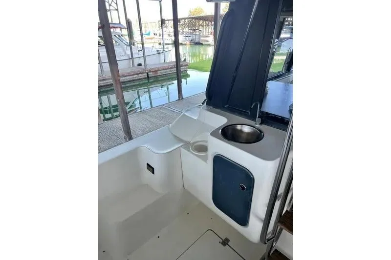 Slide: The Image of 1992 Bayliner 3688 Motoryacht cockpit with sink and seating, docked at marina. - 10