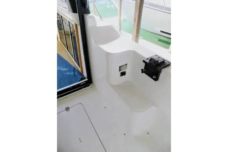 Slide: The Image of Interior view of 1992 Bayliner 3688 Motoryacht, featuring white seating and window. - 13