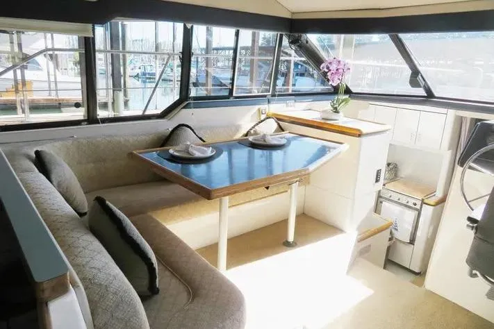 Slide: The Image of Interior of 1992 Bayliner 3688 Motoryacht with dining area and kitchenette. - 14