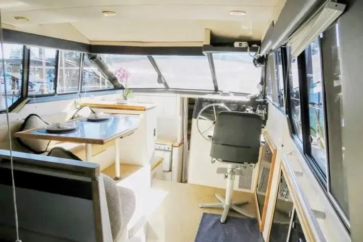 Slide: The Image of Interior of 1992 Bayliner 3688 Motoryacht with dining area and helm station. - 16