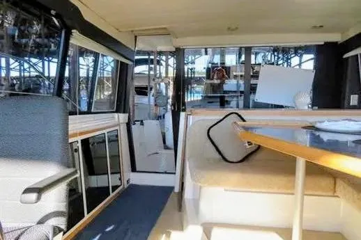 Slide: The Image of Interior of 1992 Bayliner 3688 Motoryacht, featuring seating and dining area. - 18