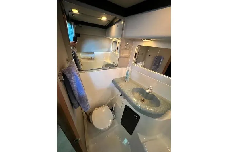 Slide: The Image of Bathroom interior of 1992 Bayliner 3688 Motoryacht with sink, mirror, and toilet. - 22
