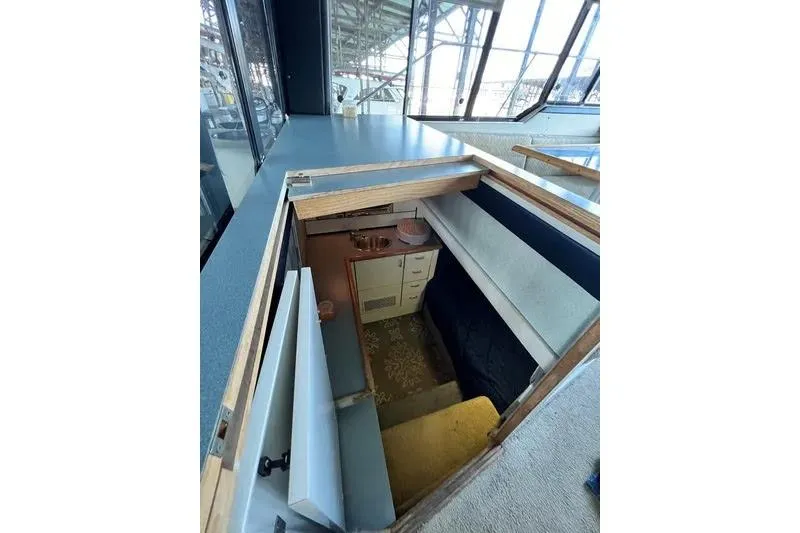 Slide: The Image of Interior view of 1992 Bayliner 3688 Motoryacht, showcasing compact kitchen area. - 23