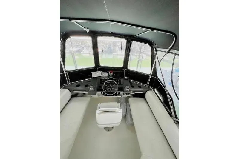 Slide: The Image of Interior view of 1992 Bayliner 3688 Motoryacht helm with seating and steering wheel. - 27