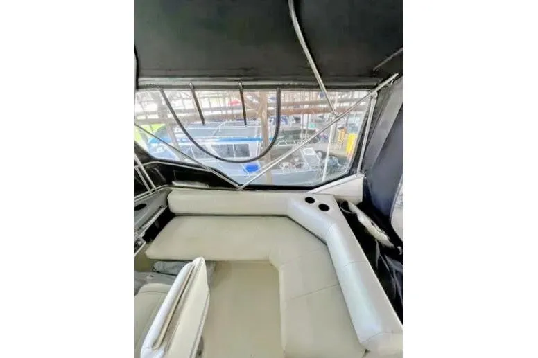 Slide: The Image of Interior view of 1992 Bayliner 3688 Motoryacht with cushioned seating and window. - 28