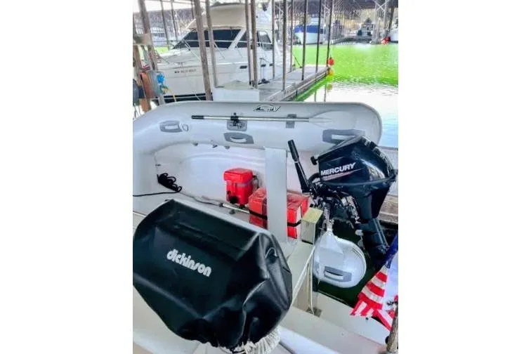 Slide: The Image of 1992 Bayliner 3688 Motoryacht with Mercury outboard motor and docked inflatable boat. - 5