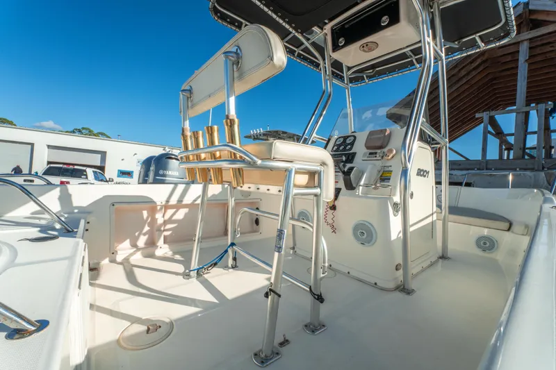 Slide: The Image of Century 2001 model boat interior, featuring helm and seating, under clear blue sky. - 10