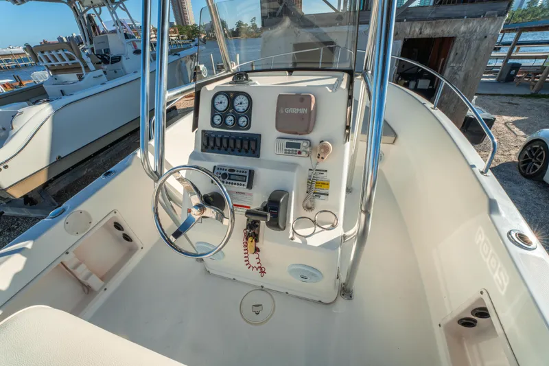 Slide: The Image of Century 2001 model boat interior, steering console with Garmin equipment, docked by the water. - 18