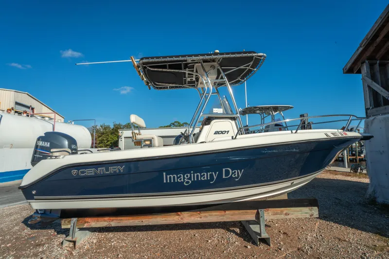 Slide: The Image of Century 2001 boat named "Imaginary Day" on display, Yamaha engine visible. - 2