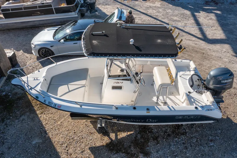 Slide: The Image of Century 2001 model boat with Yamaha engine, parked beside a silver car. - 28