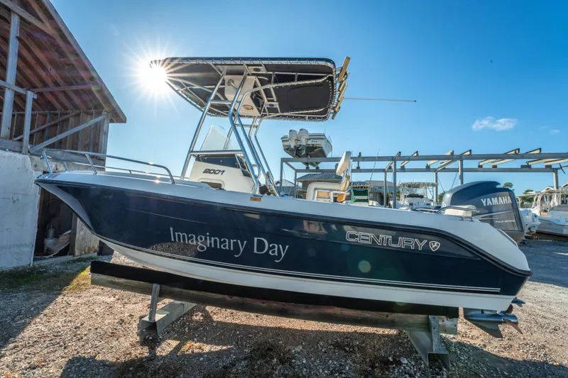 Slide: The Image of Century 2001 model boat named "Imaginary Day" with Yamaha engine, docked under clear sky. - 5