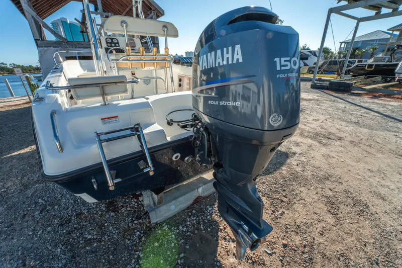 Slide: The Image of Century 2001 boat with Yamaha 150 four-stroke engine, docked on gravel. - 7