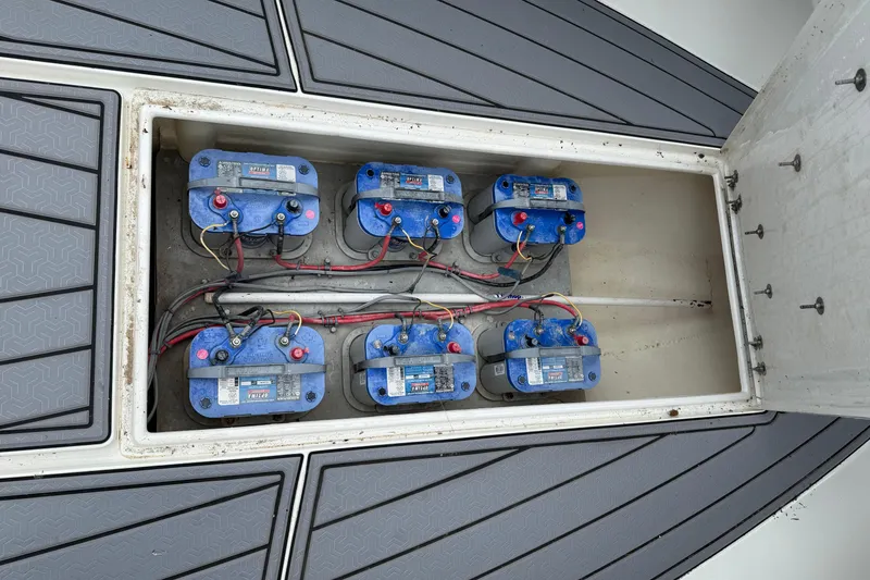 Slide: The Image of Battery compartment of a 2008 Contender 36 Open boat with six blue batteries. - 18
