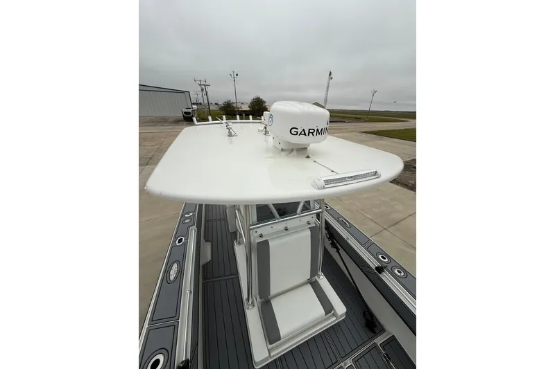 Slide: The Image of 2008 Contender 36 Open boat with Garmin radar on deck, docked outdoors. - 23