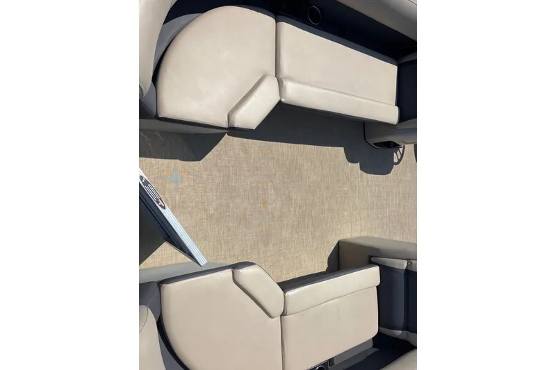 Slide: The Image of 2024 Harris HCX23 boat interior with beige seating and spacious layout. - 7