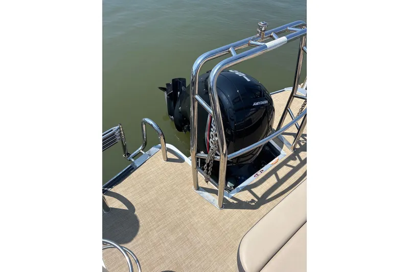 Slide: The Image of 2024 Harris HCX23 boat with Mercury outboard motor on a sunny day. - 9