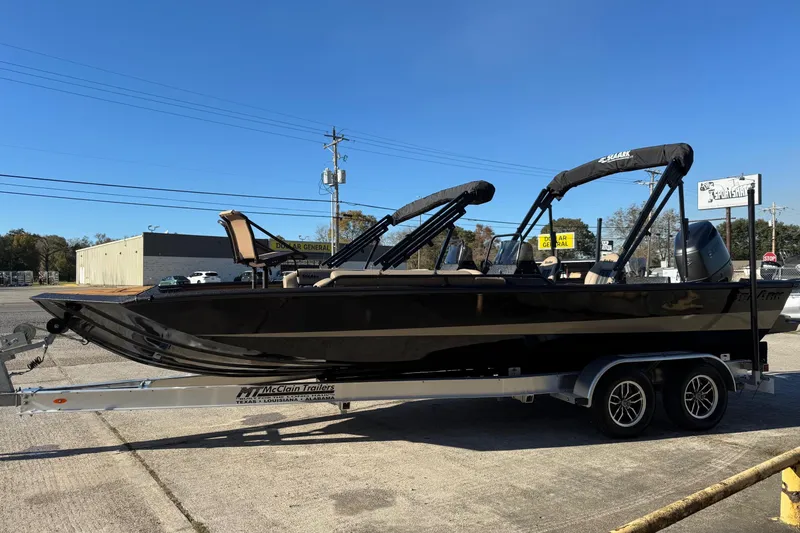 The Image of 2026 SeaArk Big Easy boat on trailer, parked outdoors under clear blue sky. - 1