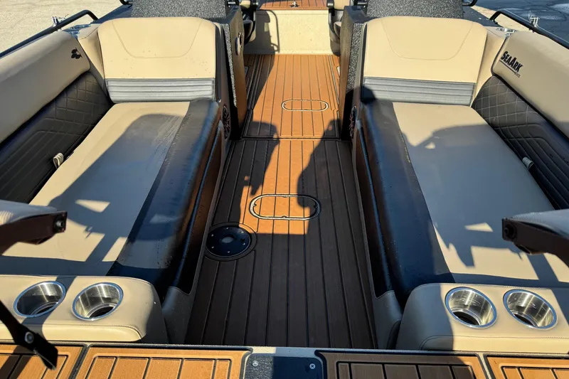 Slide: The Image of 2026 SeaArk Big Easy boat interior with tan and black seating, wood-style flooring. - 12