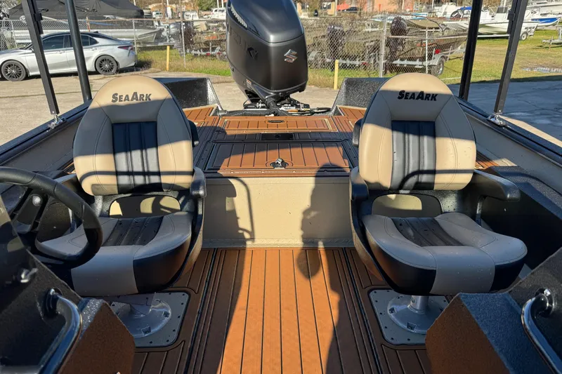 Slide: The Image of 2026 SeaArk Big Easy boat interior with two cushioned seats and wood-style flooring. - 14