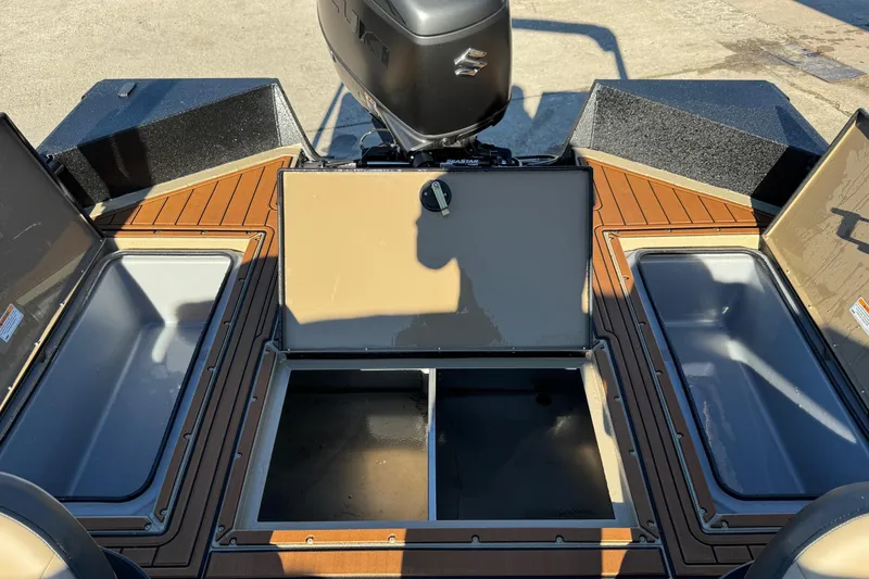 Slide: The Image of 2026 SeaArk Big Easy boat interior with storage compartments and motor. - 16
