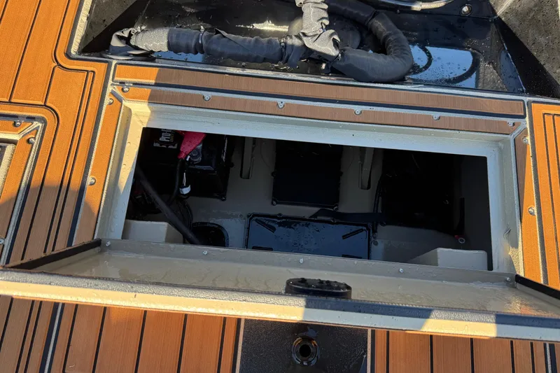 Slide: The Image of Open hatch on 2026 SeaArk Big Easy boat, revealing interior components and wiring. - 17