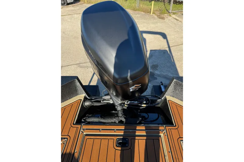 Slide: The Image of 2026 SeaArk Big Easy boat with powerful outboard motor, featuring sleek design and wood-patterned deck. - 19