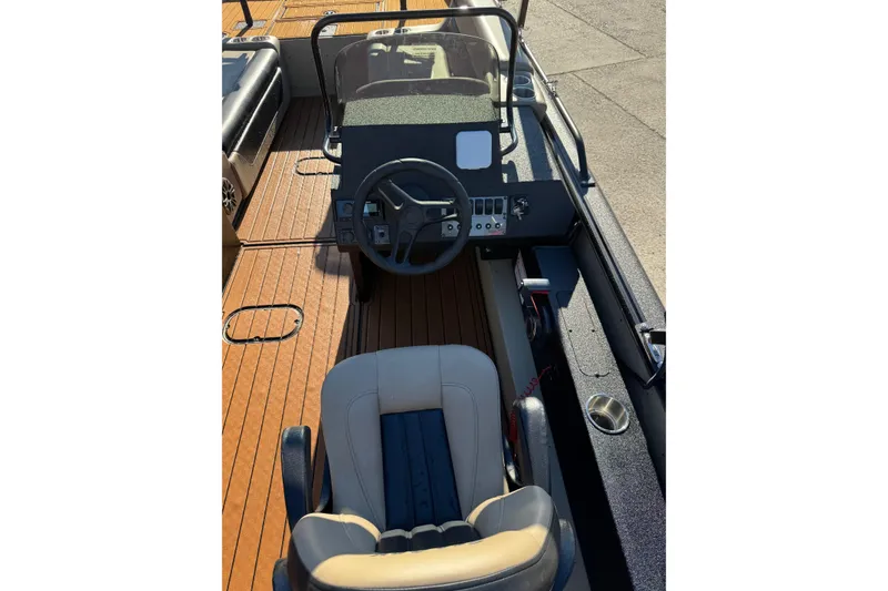 Slide: The Image of 2026 SeaArk Big Easy boat interior with steering wheel and cushioned seating. - 20