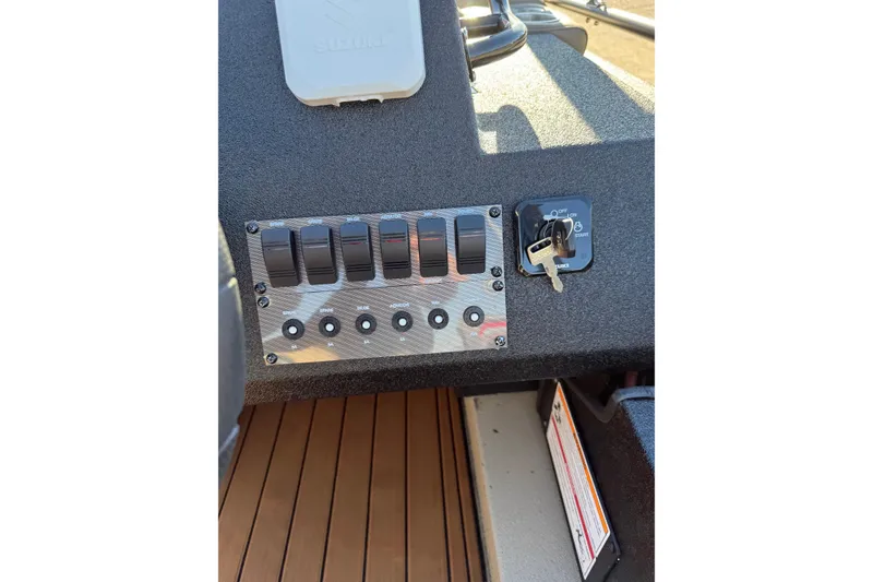 Slide: The Image of Control panel of 2026 SeaArk Big Easy boat with switches and ignition key. - 21