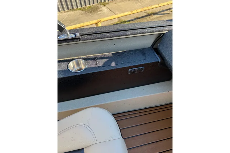 Slide: The Image of 2026 SeaArk Big Easy boat interior with cup holder and seating detail. - 24