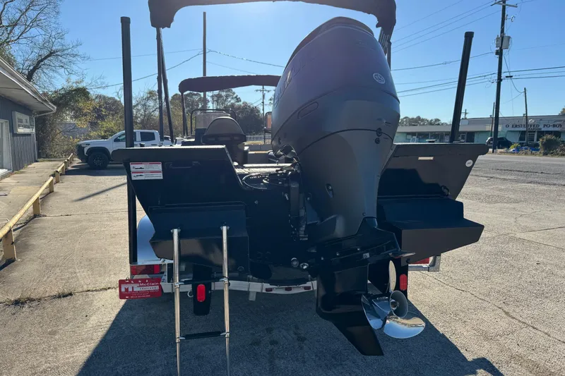 Slide: The Image of 2026 SeaArk Big Easy boat with powerful outboard motor, parked outdoors. - 4