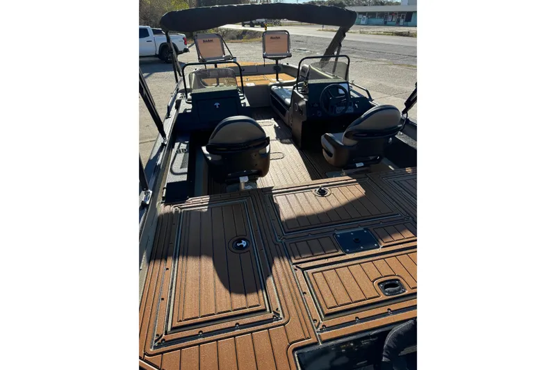 Slide: The Image of 2026 SeaArk Big Easy boat interior with seating and steering console. - 7