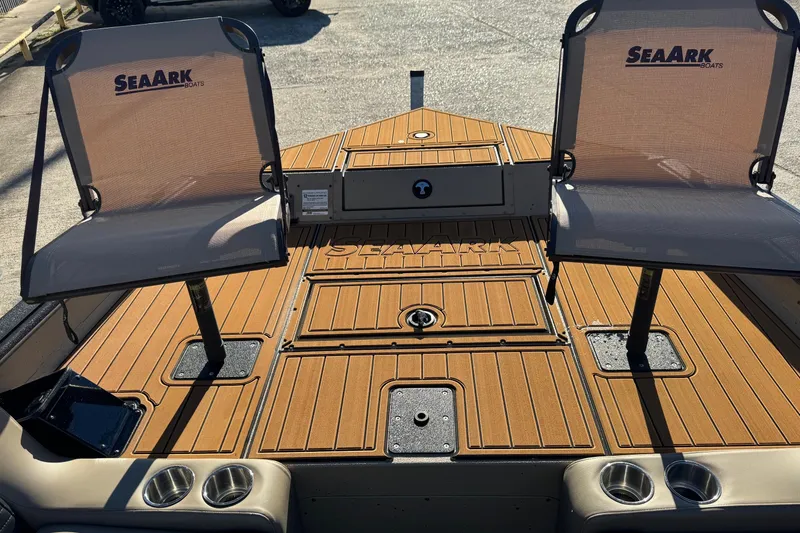 Slide: The Image of 2026 SeaArk Big Easy boat deck with two seats and cup holders. - 8