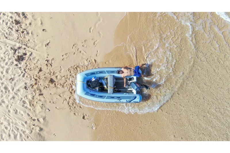 Slide: The Image of Aerial view of Highfield Classic 310 boat on beach, 2026 model. - 6