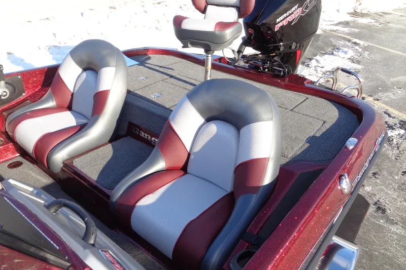 Slide: The Image of 2026 Ranger Z185 boat interior with red and gray seats, snowy background. - 10