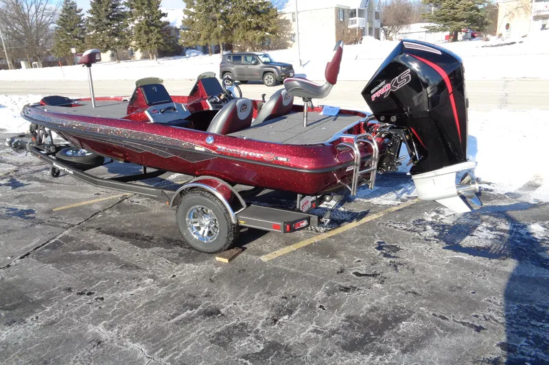 Slide: The Image of 2026 Ranger Z185 boat with trailer, parked on snowy pavement. - 12
