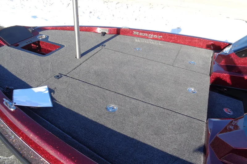 Slide: The Image of 2026 Ranger Z185 boat deck with carpeted surface and storage compartments. - 17