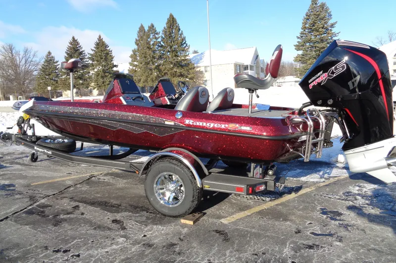 Slide: The Image of 2026 Ranger Z185 boat with Mercury Pro XS engine on a trailer in snowy setting. - 2