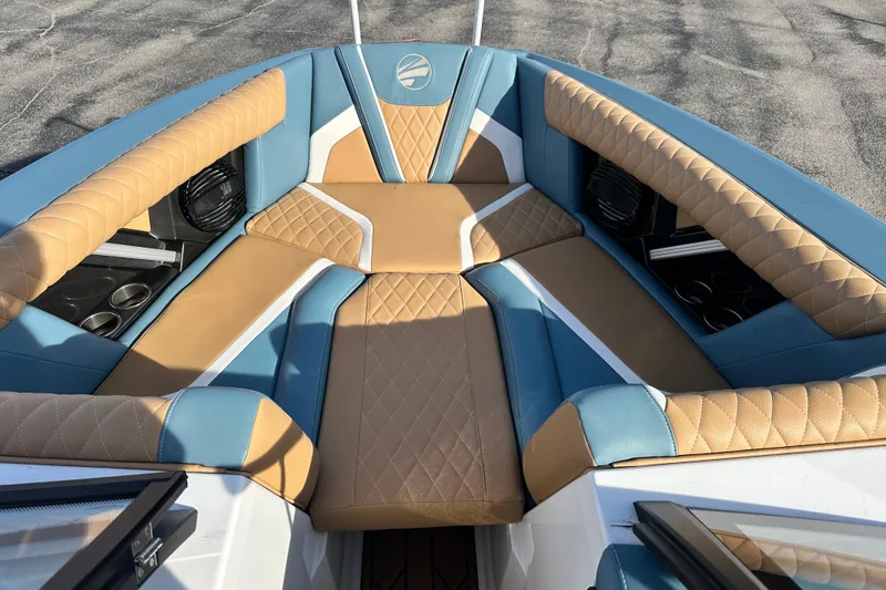 Slide: The Image of 2023 Tigé 23ZX boat interior with tan and blue quilted seating. - 11