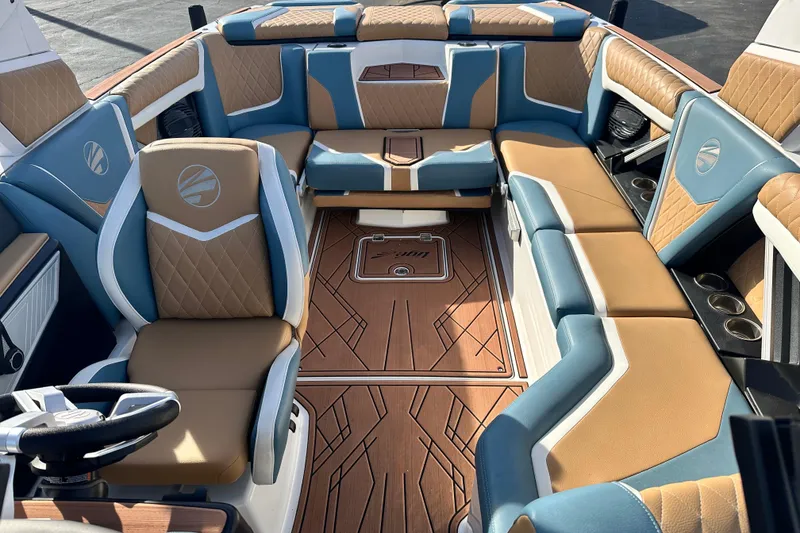 Slide: The Image of 2023 Tigé 23ZX boat interior with luxurious tan and blue seating, stylish design. - 12