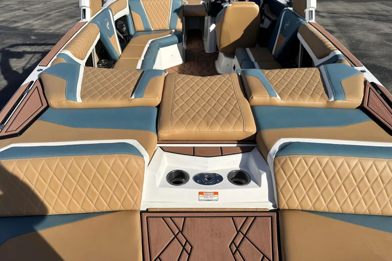 Slide: The Image of 2023 Tigé 23ZX boat interior with tan and blue diamond-stitched seating. - 6
