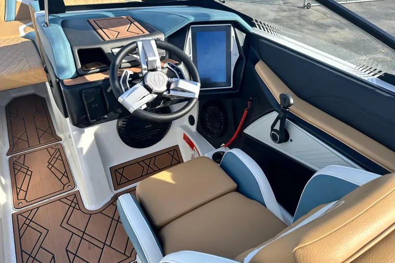 Slide: The Image of 2023 Tigé 23ZX boat interior with modern steering wheel and touchscreen display. - 9