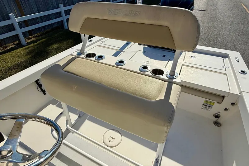 Slide: The Image of 2014 Pathfinder 2400 TRS boat interior with beige seating and cup holders. - 10