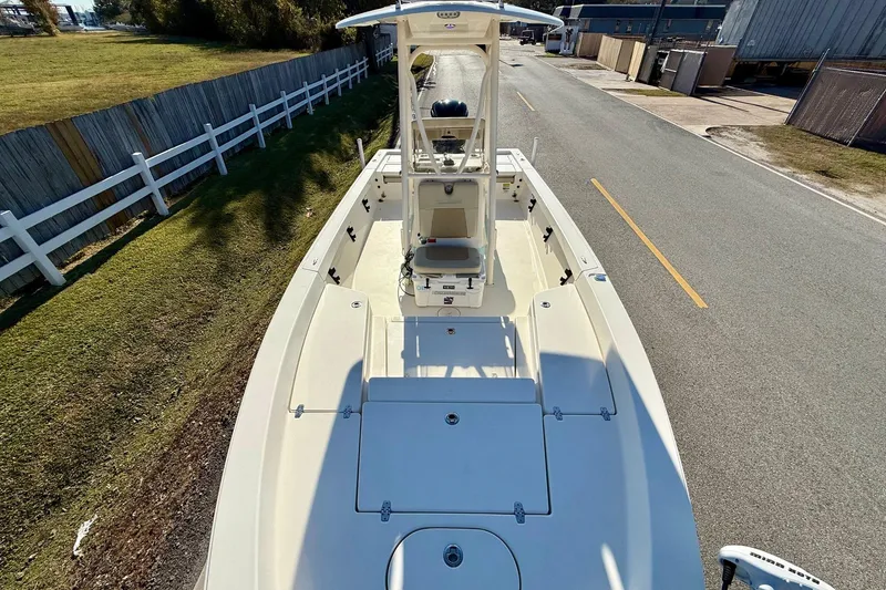 Slide: The Image of 2014 Pathfinder 2400 TRS boat on road, top view, near white fence and grass. - 16
