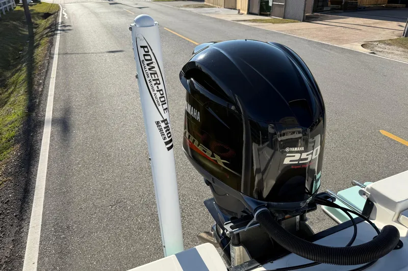 Slide: The Image of 2014 Pathfinder 2400 TRS with Yamaha 250 engine and Power-Pole Pro Series on a road. - 20