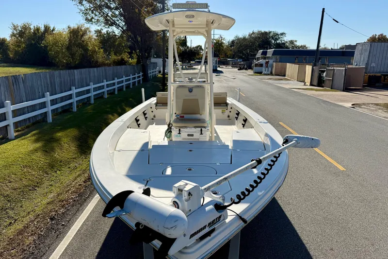 Slide: The Image of 2014 Pathfinder 2400 TRS boat on a road, featuring a trolling motor. - 6