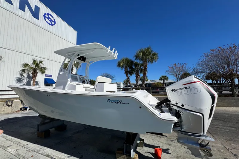 Slide: The Image of 2022 Front Runner 26 Center Console boat with Racing 300 engine, docked outdoors. - 10