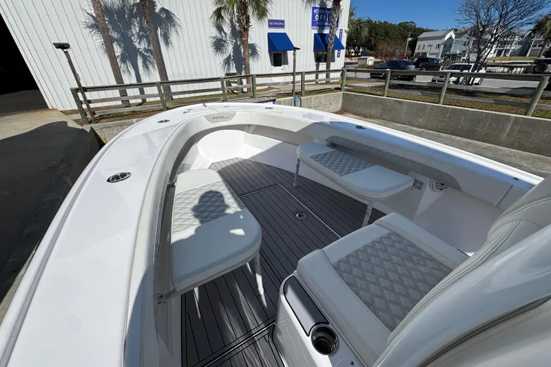 Slide: The Image of 2022 Front Runner 26 Center Console boat interior with cushioned seating and sleek design. - 18