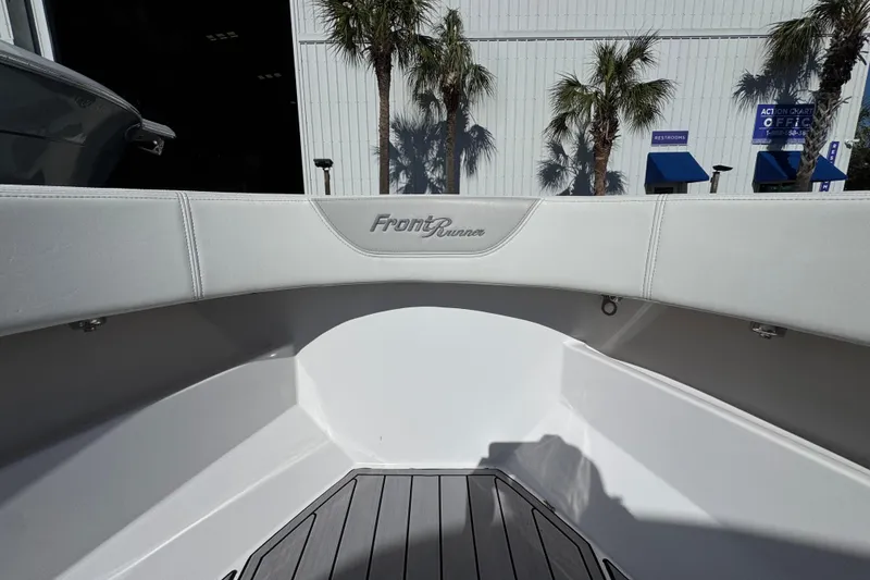 Slide: The Image of 2022 Front Runner 26 Center Console boat interior with logo, palm trees, and building background. - 19